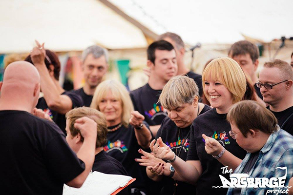 Members of Hands & Voices choir performing at the Arts Barge event
