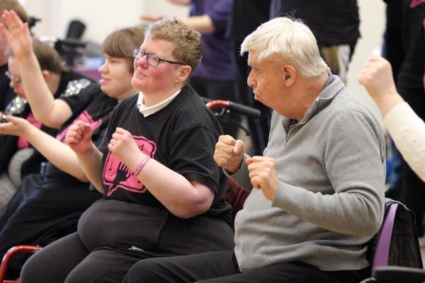 Hands & Voices members sing and sign together for the crowd