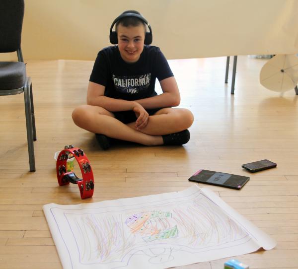 A Senior IMPs smiles in front of their carriage design