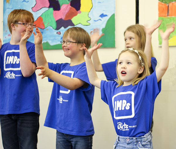 Members of the Junior IMPs group singing and signing