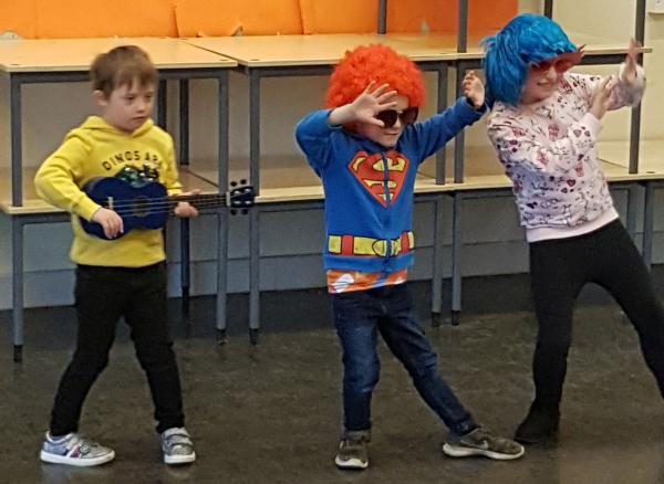 Three of our IMPs holiday club members wearing funny wigs and performing