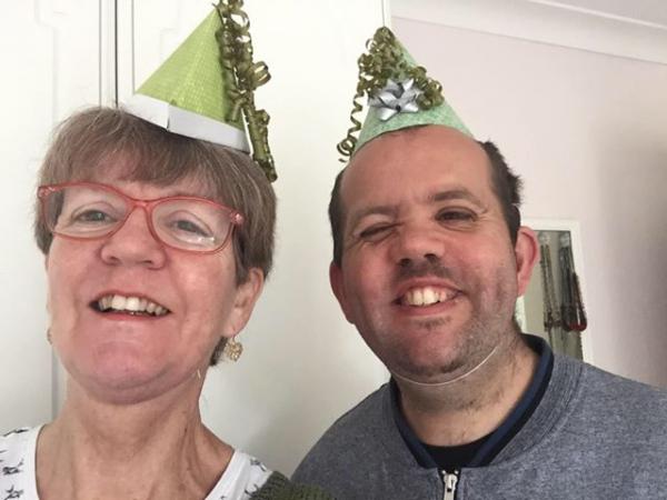 A photograph of Dan and his Mum taking part in one of our Sensory Story sessions
