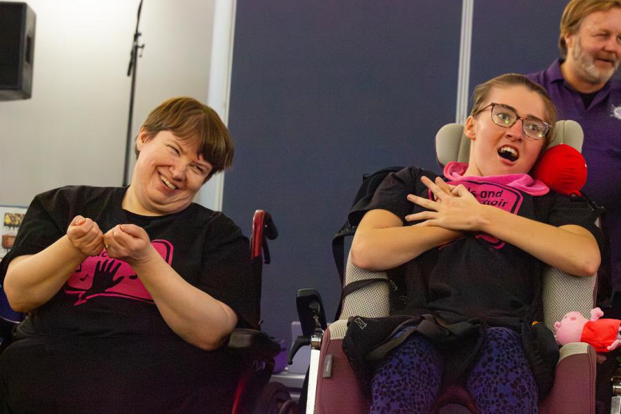 Members of Hands & Voices spilling as they sing and sign